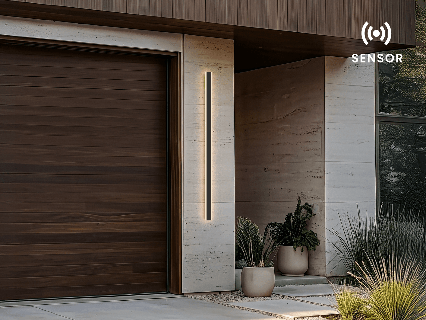 Haylen LED bar wall light lit beside a wood garage door, marked with a sensor icon